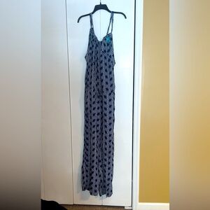 Navy full length jumpsuit. Has pockets and a cinched tie at waist